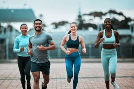 Sculpting Sleek Arms: The Essential Role of Cardio in Toning Without Bulking Up 3 image of people running to incorporate cardio Belper exercise into their life to help tone arms and body.