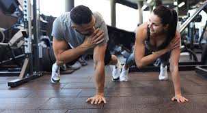 Image of man and woman doing Cardio Belper to tone their arms. 